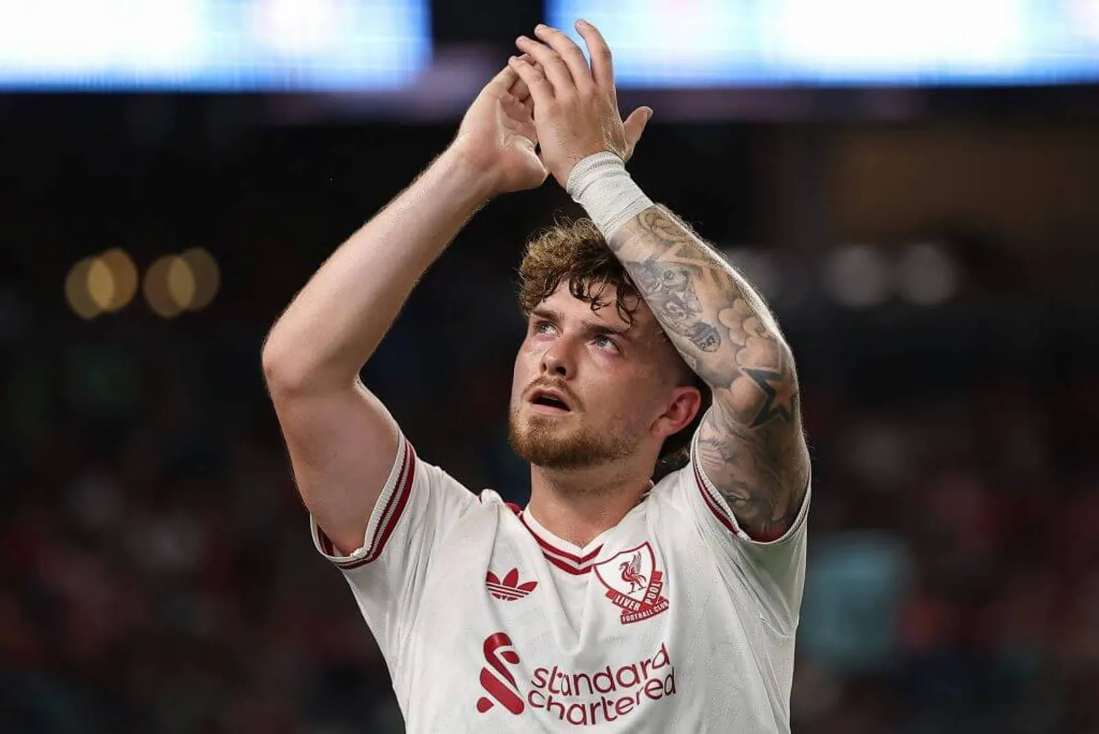 Harvey Elliott of Liverpool FC walks to the bench and applauds