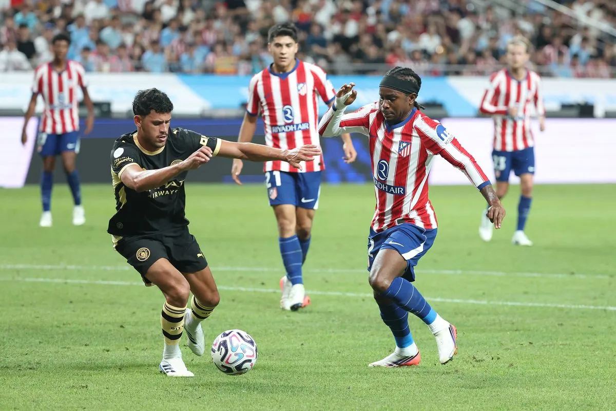 Ademola Lookman of Atletico Madrid competes for the ball with Matheus Nunes of Manchester City during the preseason friendly